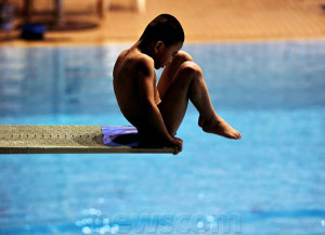 boy of the diving team of the Fuzhou Sports School prepares to dive ...