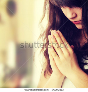 Closeup portrait of a young caucasian woman praying - stock photo