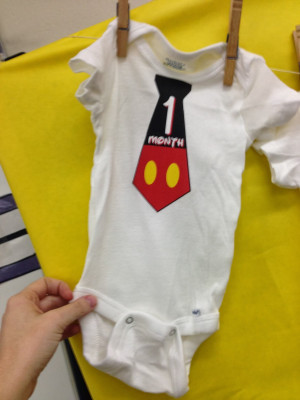 Our gift to her was a year of monthly onesies that were Disney themed ...