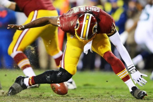 Robert Griffin III injured his knee on this play. (Al Bello / Getty ...