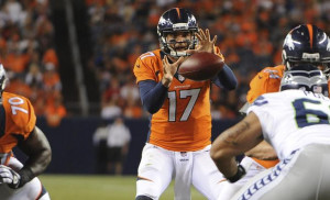 Broncos quarterback Brock Osweiler takes the snap against the Seattle ...