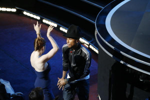 Pharrell Williams, dancing with Amy Adams as he works the crowd, sings ...