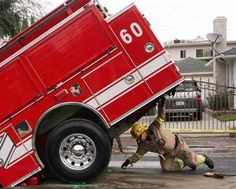Super Hero Firefighter? NBC News Caption Said Fireman Holds Up a Fire ...