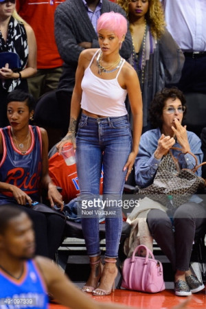 News Photo Rihanna attends an NBA playoff game between the