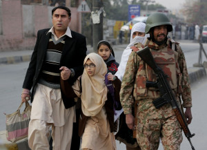 their children outside a school attacked by the Taliban in Peshawar ...