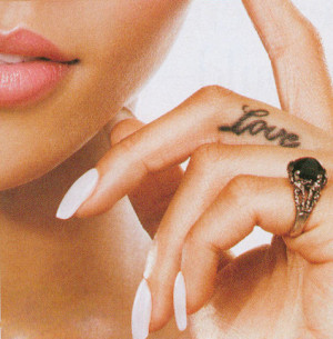 Very feminine middle finger Love word tattoo idea, by Rihanna