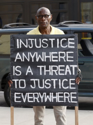 Thomas Tolliver held a sign with a quote from Martin Luther King Jr.'s ...