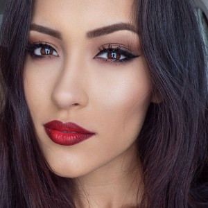 Bold red lip color paired with cat eye.