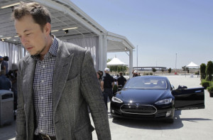 Tesla CEO Elon Musk walks past the Tesla Model S Source: Associated ...