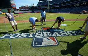 Atlanta Braves grounds crew members fill in the Major League Baseball ...