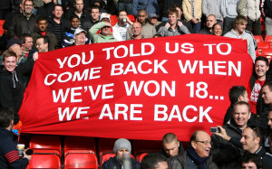 7960439 - Fans unveil a banner in the stands at Anfield