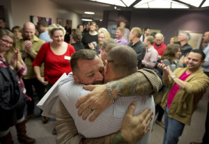 same-sex couple embraces after being married at the county clerk's ...