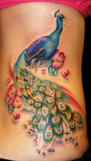 Above: This colorful tattoo of a peacock is completed with flowers ...