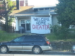 ... wife welcomes him home with sign that says 'Welcome Home Cheater