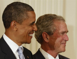 Former U.S. President Bush and U.S. President Obama look on before ...