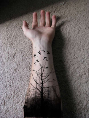 on the arm with no leaves and birds flying from the tree up to the ...