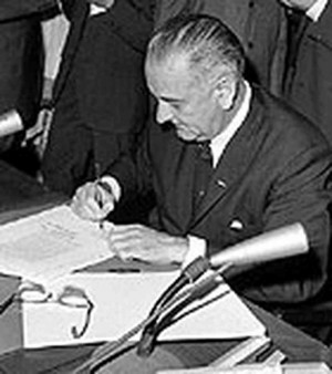 ... President Johnson signs the Civil Rights Act into law, July 2, 1964