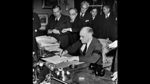 President Franklin D. Roosevelt (wearing black armband) signing ...