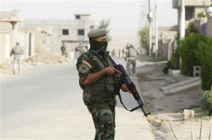 Kurdish Peshmerga soldier from the Golden Lions forces, stands guard ...