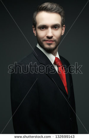Portrait of a young handsome man (businessman) in black suit with ...