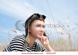 Young Woman Wearing Aviator Hat Look Into The Distance