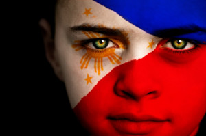 ... of a boy with athe flag of the Philippines painted on his face