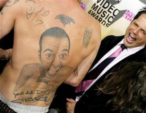 Steve-O (L) of the MTV show ''Jack Ass'' shows off his tattooed back ...