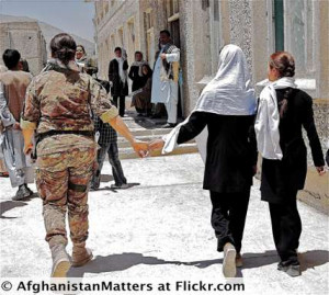 Soldier And Civilian Walking Hand In Hand In Afghanistan