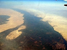 It flows through old hushed Egypt and its sands,