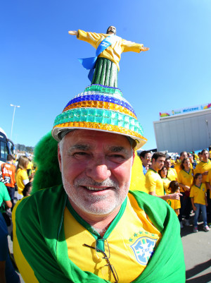 Brazil fan sports a hand made hat adorned with one of the country's ...