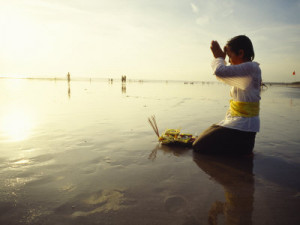 Kneeling Hindu Balinese Woman Prays and Gives Offerings at Sunset ...