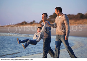 Hispanic family playing on beach together