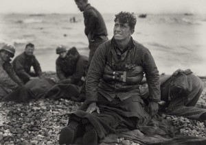... soldiers on Omaha Beach recover the dead after the D-Day invasion