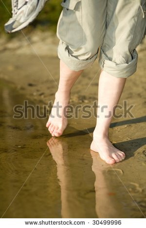 ... barefoot-girl-walking-on-the-beach-leaving-footprints-on-the-sand