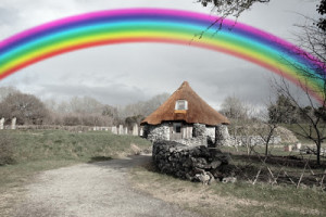 ancient rustic cottage with rainbow