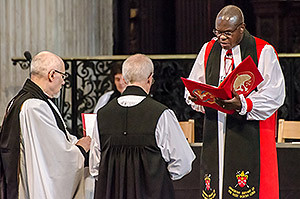 Justin Welby kneels before the Archbishop of York as he is made