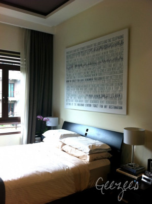 large distressed canvas word art over bed