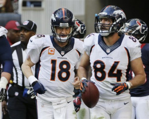 Denver Broncos\' Peyton Manning (18) runs off the field after throwing ...