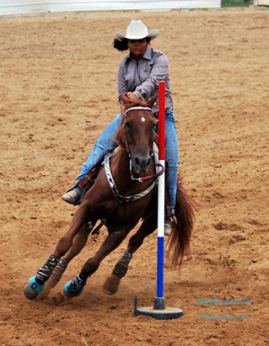 Kayla barrel racing on her gelding named Ice.