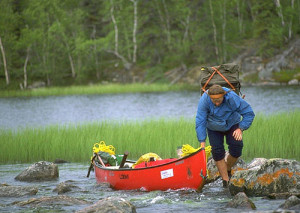 Geoffrey Peake lightens the load of his canoe before dragging it ...