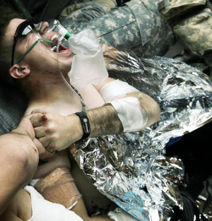 Troop 1-71 CAV reacts and hold hands with another injured soldier ...