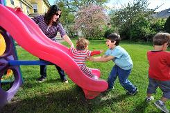 Jodie Casagrande, a stay-at-home mom, plays with her three sons, Roman ...