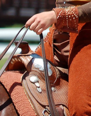 Proper rider attire includes a cowboy hat, chaps and Western boots.