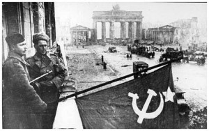 Russians soldiers wave their flag near the Brandenburg Gate in Berlin