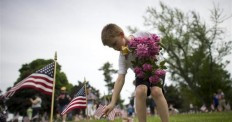 Alex Teeter, 8, places flowers on the grave sites of Battle of ...