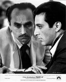 What drink does Fredo order while sitting at this cafe?