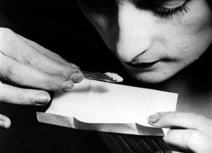 close up of a young woman snorting cocaine during the 1920s...