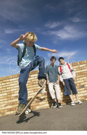 Boy Skateboarding With Friends
