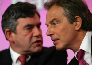 Tony Blair listens to Gordon Brown at their joint news conference.