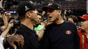 Head coach John Harbaugh of the Baltimore Ravens, left, shakes hands ...
